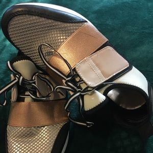 Gold and black “sneakers”